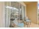 Balcony with blue cushioned wicker furniture and sliding glass doors at 7671 Comrow St # 303, Kissimmee, FL 34747