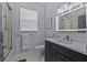 Contemporary bathroom with a sleek vanity, walk-in shower, and modern fixtures at 7671 Comrow St # 303, Kissimmee, FL 34747