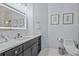 Well-lit bathroom with a large dark vanity and modern fixtures at 7671 Comrow St # 303, Kissimmee, FL 34747