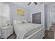 Bright bedroom featuring a large bed with grey double doors and an ensuite bathroom at 7671 Comrow St # 303, Kissimmee, FL 34747