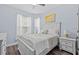 Bright bedroom featuring a large bed, and light streaming through the windows at 7671 Comrow St # 303, Kissimmee, FL 34747