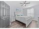 Cozy bedroom with ceiling fan, a large bed, and wood-look floors at 7671 Comrow St # 303, Kissimmee, FL 34747
