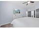Bright bedroom with TV, ceiling fan, and dark gray doors at 7671 Comrow St # 303, Kissimmee, FL 34747