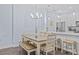 Light and airy dining area with modern light fixture and breakfast bar at 7671 Comrow St # 303, Kissimmee, FL 34747