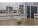 Close up showing dining area adjacent to modern kitchen with white cabinets and stainless appliances at 7671 Comrow St # 303, Kissimmee, FL 34747