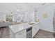 Beautiful kitchen featuring white cabinets, stainless steel appliances, and a breakfast bar at 7671 Comrow St # 303, Kissimmee, FL 34747