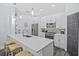 Modern kitchen with white cabinetry, stainless steel appliances, and a breakfast bar at 7671 Comrow St # 303, Kissimmee, FL 34747
