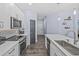 Well-equipped kitchen featuring modern appliances, white cabinetry, and stylish backsplash at 7671 Comrow St # 303, Kissimmee, FL 34747