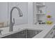 Close-up of a modern kitchen sink with stainless steel fixtures and light countertops at 7671 Comrow St # 303, Kissimmee, FL 34747