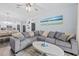 Comfortable living room featuring a large sectional sofa and modern décor at 7671 Comrow St # 303, Kissimmee, FL 34747