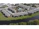Aerial view of community with parking, landscaping, and a tranquil pond at 777 W Lancaster Rd # A-13, Orlando, FL 32809