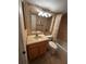 Bathroom featuring tan tiled walls, a tiled floor, wood vanity and a shower tub with curtain at 777 W Lancaster Rd # A-13, Orlando, FL 32809