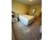 Bedroom featuring tiled floors, neutral paint, and side tables with lamps at 777 W Lancaster Rd # A-13, Orlando, FL 32809