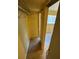 Hallway with tile flooring leads to bedroom with natural light from window at 777 W Lancaster Rd # A-13, Orlando, FL 32809