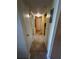 Hallway featuring tiled flooring, neutral paint and white doors with an overhead light fixture at 777 W Lancaster Rd # A-13, Orlando, FL 32809