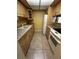 A kitchen with light wood cabinets, neutral countertops, and white appliances including a range and refrigerator at 777 W Lancaster Rd # A-13, Orlando, FL 32809