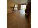 Bright living room with tile floors, sliding glass doors, and a decorative cabinet at 777 W Lancaster Rd # A-13, Orlando, FL 32809