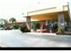 Inviting exterior view of the building's entrance, featuring well-maintained landscaping and ample parking at 7900 S Orange Blossom Trl # 2075, Orlando, FL 32809