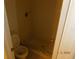 Full bathroom with toilet and shower, tiled in neutral colors at 84 Silver Park Cir, Kissimmee, FL 34743