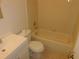 Bathroom with a vanity sink, toilet, and soaking tub with tile surround at 84 Silver Park Cir, Kissimmee, FL 34743