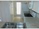 Practical kitchen with a double sink, white appliances, and access to the outside at 84 Silver Park Cir, Kissimmee, FL 34743