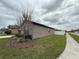 Side view of a well-maintained home, showcasing the clean landscaping and spacious yard at 8835 Conway Rd, Polk City, FL 33868