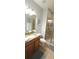 Bathroom with a granite-topped vanity, a glass-enclosed shower, and neutral tile flooring at 8961 California Palm Rd, Kissimmee, FL 34747