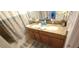 Bathroom featuring double vanity with granite countertop and decorative accents at 8961 California Palm Rd, Kissimmee, FL 34747