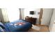 Bright bedroom with cartoon-themed bedding, a dresser, and ample closet space at 8961 California Palm Rd, Kissimmee, FL 34747