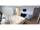 Bedroom featuring a relaxing chair, and a wall-mounted TV for entertainment at 8961 California Palm Rd, Kissimmee, FL 34747