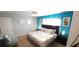 Bright bedroom showcasing a comfortable queen bed and light-filled atmosphere at 8961 California Palm Rd, Kissimmee, FL 34747