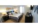 Bedroom with mounted TV, palm tree decor, and carpet floors at 8961 California Palm Rd, Kissimmee, FL 34747