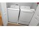 Laundry area featuring a washer and dryer, and tiled floor at 8961 California Palm Rd, Kissimmee, FL 34747