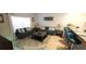 Bright living room featuring comfortable seating, stylish decor, and a breakfast bar with seating at 8961 California Palm Rd, Kissimmee, FL 34747