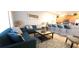 Inviting living room with comfortable sofas, stylish coffee table, and breakfast bar at 8961 California Palm Rd, Kissimmee, FL 34747