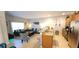 Open-concept living and kitchen area with modern decor, comfortable seating, and ample natural light at 8961 California Palm Rd, Kissimmee, FL 34747