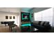 Stylish living area with a modern entertainment center, comfortable seating, and ample natural light at 8961 California Palm Rd, Kissimmee, FL 34747