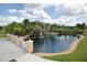Community pond with calming waterfall and decorative bridge with lush landscaping at 8961 California Palm Rd, Kissimmee, FL 34747