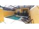 Screened in swimming pool with two lounge chairs provides a private outdoor oasis at 8961 California Palm Rd, Kissimmee, FL 34747