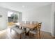 Bright dining room features a wooden table with seating and sliding glass door to the backyard at 956 Cambridge Dr, Winter Haven, FL 33881