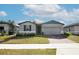 Charming single-story home with well-manicured lawn and brick paver driveway at 956 Cambridge Dr, Winter Haven, FL 33881