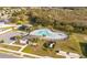 Aerial view of community pool, palm trees, covered pavilion, and parking at 956 Cambridge Dr, Winter Haven, FL 33881