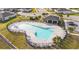 Aerial view of a community pool with lounge chairs, palm trees, and a covered pavilion at 956 Cambridge Dr, Winter Haven, FL 33881