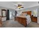 Inviting bedroom with wood accents, large bed, ceiling fan, and private backyard access at 6845 Old Melbourne Hwy, St Cloud, FL 34771
