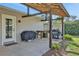 Outdoor kitchen featuring a grill, counter space, and pergola perfect for barbecues and entertaining at 6845 Old Melbourne Hwy, St Cloud, FL 34771