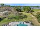 Aerial view of a backyard featuring a swimming pool, hot tub, green lawns, and trees near a river at 6845 Old Melbourne Hwy, St Cloud, FL 34771