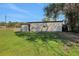 Exterior view of a shed with a star detail, surrounded by a well-kept lawn, offering ample storage space at 6845 Old Melbourne Hwy, St Cloud, FL 34771