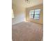 Cozy carpeted bedroom with a large window, providing ample natural light at 1001 Via Santae Ln # 201, Celebration, FL 34747