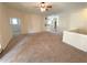 Bright and airy living room with neutral carpeting, and open space leading to other rooms at 1001 Via Santae Ln # 201, Celebration, FL 34747