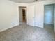 Bedroom with neutral walls and carpet, showcasing doorways and a closet for storage at 1017 Siena Park E Blvd, Celebration, FL 34747